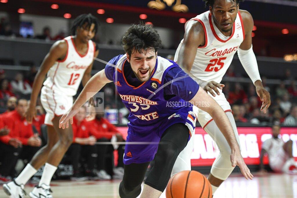 Justin Rex Northwestern State forward Zurabi Zhgenti (35) and Houston center Josh Carlton (25) watch the ball during the first half of an NCAA college basketball game Tuesday, Nov. 30, 2021, in Houston. (AP Photo/Justin Rex)
