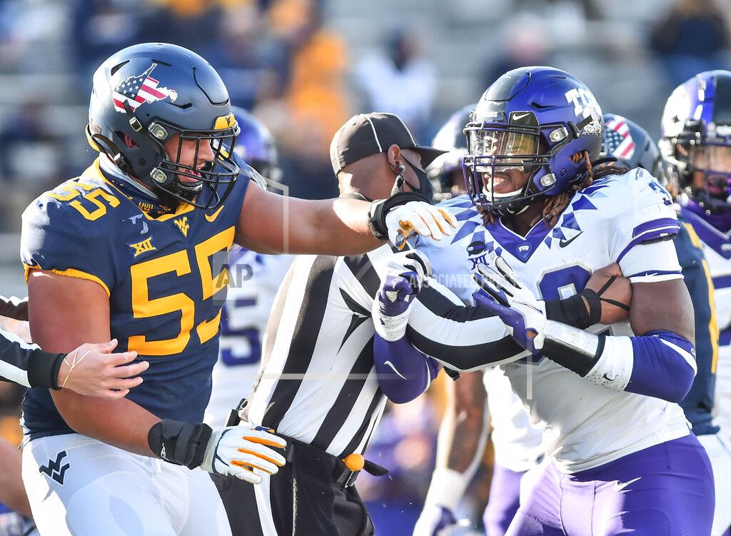 William Wotring TCU defensive end Ochaun Mathis (32) and West Virginia offensive lineman Parker Moorer (55) shoving after the whistle during the second half of an NCAA college football game on Saturday, Nov. 14, 2020, in Morgantown, W.Va. (William Wotring/The Dominion-Post via AP)