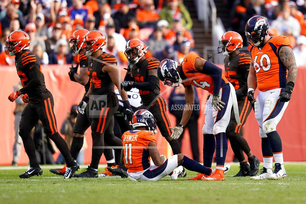 Jack Dempsey Denver Broncos wide receiver Diontae Spencer (11) is helped up by teammate Courtland Sutton (14) after fumbling the football against the Cleveland Browns during the first half of NFL football game, Sunday, Nov. 3, 2019, in Denver. The Browns recovered the ball. (AP Photo/Jack Dempsey)