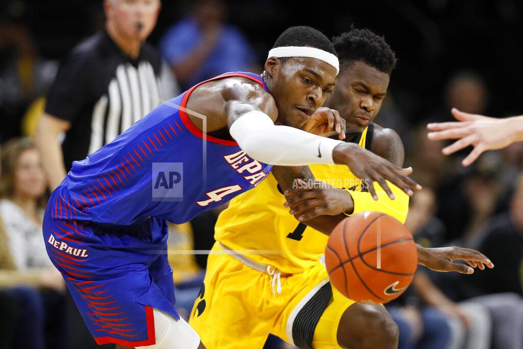 Charlie Neibergall DePaul forward Paul Reed (4) grabs a loose ball ahead of Iowa guard Joe Toussaint during the second half of an NCAA college basketball game, Monday, Nov. 11, 2019, in Iowa City, Iowa. DePaul won 93-78. (AP Photo/Charlie Neibergall)