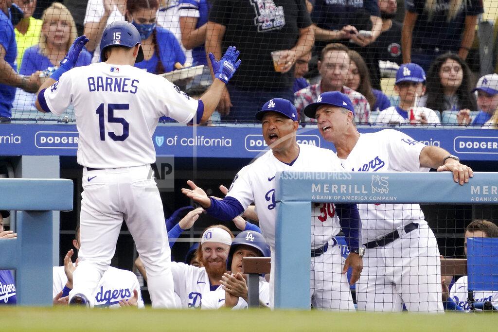 Mark J. Terrill Los Angeles Dodgers' Austin Barnes, left, is congratulated by manager Dave Roberts, second from right, and bench coach Bob Geren, right, after hitting a solo home run during the second inning of a baseball game against the Colorado Rockies Saturday, July 24, 2021, in Los Angeles. (AP Photo/Mark J. Terrill)