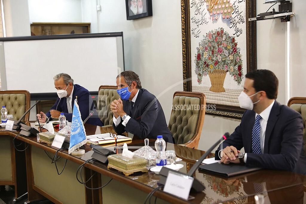 Uncredited Rafael Mariano Grossi, Director General of International Atomic Energy Agency, IAEA, center, attends a meeting with the Head of Atomic Energy Organization of Iran, Mohammad Eslami, in Tehran, Iran, Sunday, Sept. 12, 2021. Iran agreed Sunday to allow international inspectors to install new memory cards into surveillance cameras at its sensitive nuclear sites and to continue filming there, averting a diplomatic showdown this week. (Atomic Energy Organization of Iran via AP)