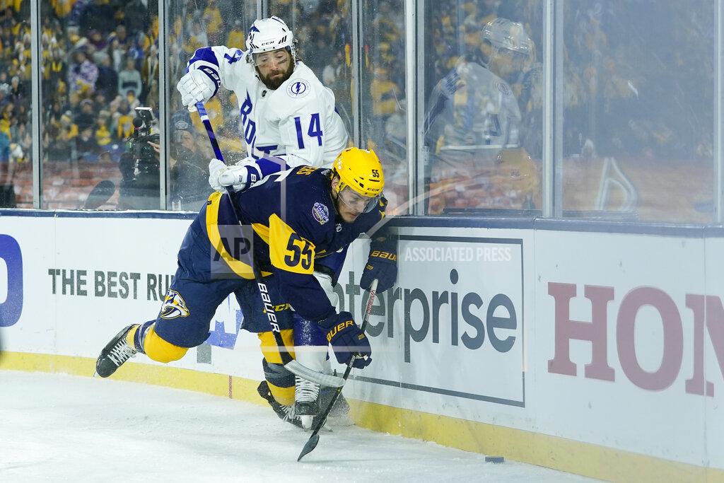 Mark Humphrey Tampa Bay Lightning left wing Pat Maroon (14) and Nashville Predators defenseman Philippe Myers (55) battle for the puck in the second period of an NHL Stadium Series hockey game Saturday, Feb. 26, 2022, in Nashville, Tenn. (AP Photo/Mark Humphrey)