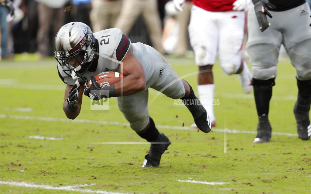 Rogelio V. Solis Mississippi State running back Nick Gibson (21) dives into the end zone for a short yardage touchdown against Arkansas during the first half of an NCAA college football game in Starkville, Miss., Saturday, Nov. 17, 2018. (AP Photo/Rogelio V. Solis)