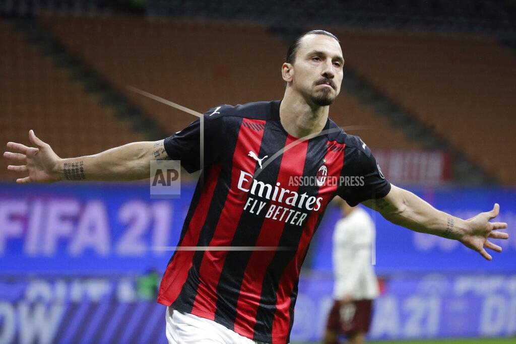 AC Milan's Zlatan Ibrahimovic celebrates after scoring his side's opening goal during the Serie A soccer match between AC Milan and Roma at the Milan San Siro Stadium, Italy, Monday, Oct. 26, 2020. (AP Photo/Luca Bruno)
