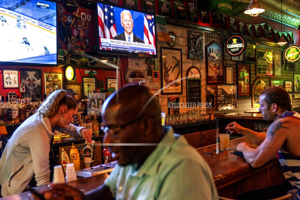 David Goldman A broadcast of Democratic presidential candidate former Vice President Joe Biden speaking at the Democratic National Convention plays on a television at The Durty Leprechaun in Appleton, Wis., Aug. 20, 2020. Donald Trump won the presidency by wringing tens of thousands of votes out of small towns and medium-sized cities in Wisconsin, Michigan and Pennsylvania. How enduring the divide will be is one of the central tests of the presidential election. Will emotional ties to Trump override assessments of his job performance? (AP Photo/David Goldman)