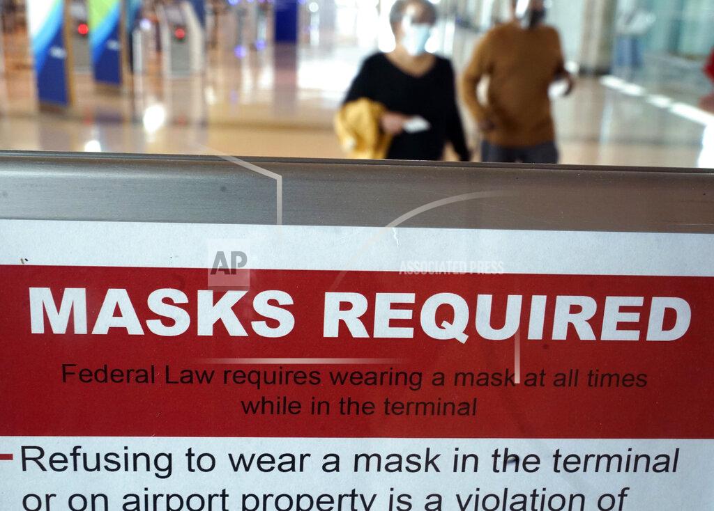 Lm Otero To prevent the spread of Covid-19, a sign directs travelers to wear masks at Love Field Tuesday, March 2, 2021, in Dallas. (AP Photo/LM Otero)