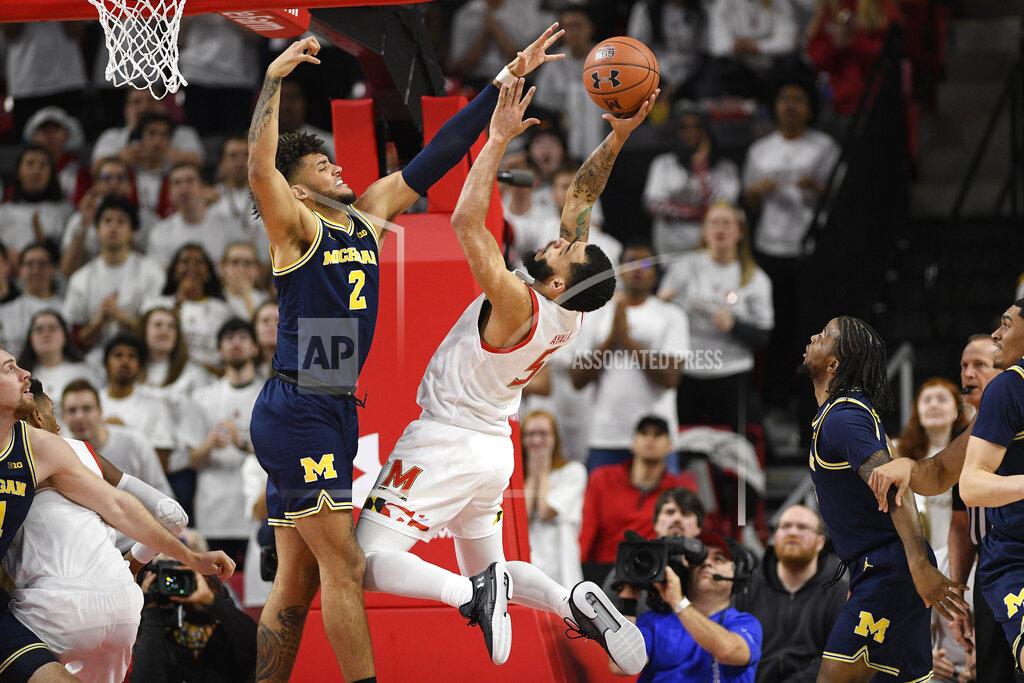 Nick Wass Maryland guard Eric Ayala (5) goes to the basket next to Michigan forward Isaiah Livers (2) during the first half of an NCAA college basketball game, Sunday, March 8, 2020, in College Park, Md. (AP Photo/Nick Wass)