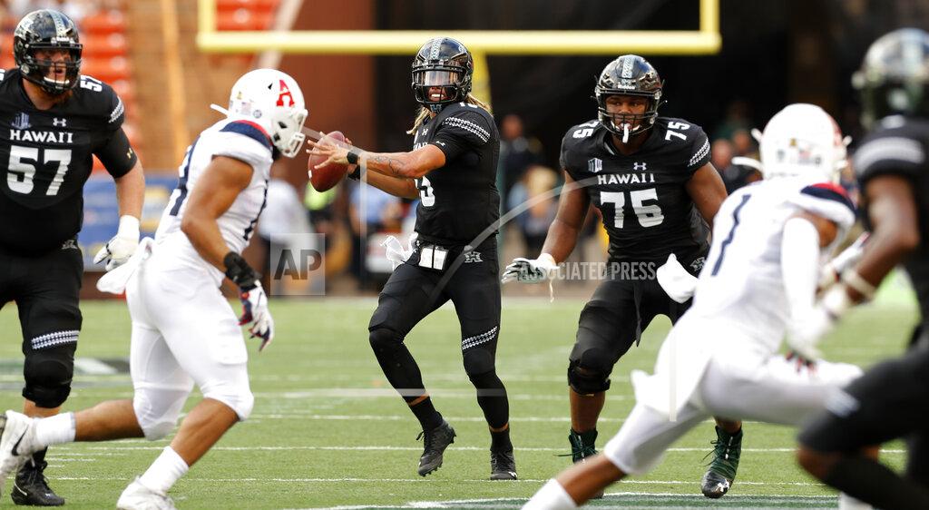 Marco Garcia Hawaii quarterback Cole McDonald (13) looks looks for a receiver during the second quarter of the team's NCAA college football game against Arizona on Saturday, Aug. 24, 2019, in Honolulu. (AP Photo/Marco Garcia)