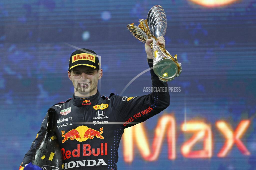Kamran Jebreili Red Bull driver Max Verstappen of the Netherlands celebrates on the podium after becoming F1 drivers world champion after winning the Formula One Abu Dhabi Grand Prix in Abu Dhabi, United Arab Emirates, Sunday, Dec. 12. 2021. (AP Photo/Kamran Jebreili, Pool)