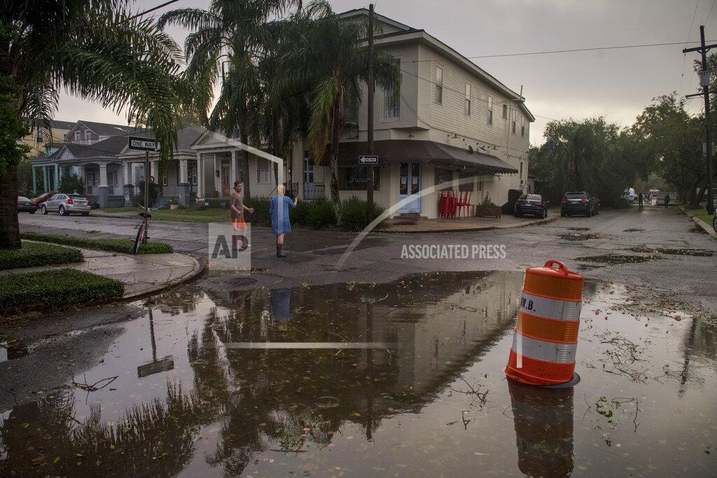 Chris Granger Residents come out to assess the damage from Hurricane Zeta on Wednesday, Oct. 28, 2020, near the restaurant Patois in New Orleans. (Chris Granger/The Times-Picayune/The New Orleans Advocate via AP)