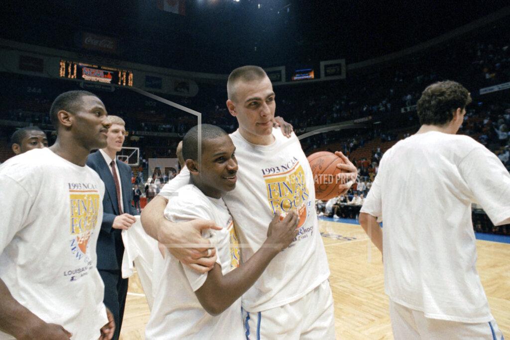 Bill Kostroun FILE - In this March 28, 1993, file photo, North Carolina's Donald Williams, center left, celebrates with teammate Eric Montross, center right, after Williams hit two three-point baskets in overtime to help North Carolina defeat Cincinnati 75-68 in an NCAA East Regional championship game at the Meadowlands Arena in East Rutherford, N.J. The player on the left is unidentified. Williams scored 25 points each in North Carolina’s semifinal victory over Kansas and its championship game triumph over Michigan. (AP Photo/Bill Kostroun, File)