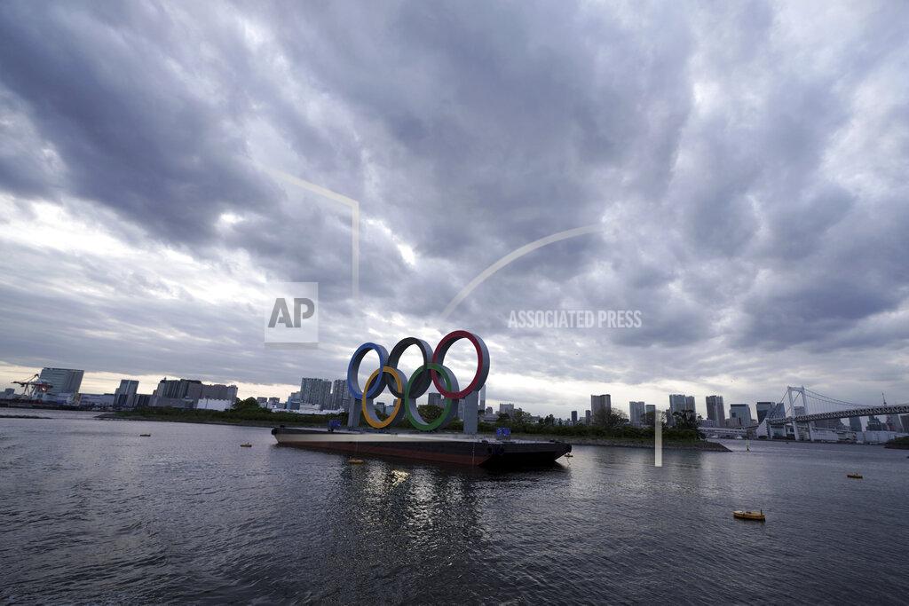 FILE - This April 12, 2021, file photo shows the Olympic rings floating in the water in the Odaiba section in Tokyo. Some nurses in Japan are incensed at a request from Tokyo Olympic organizers to have 500 of them dispatched to help out with the games. They say they’re already near the breaking point dealing with the coronavirus pandemic. A protest message saying that nurses were opposed to holding the Olympic went viral on Japanese Twitter recently, being retweeted hundreds of thousands of times. (AP Photo/Eugene Hoshiko, File)