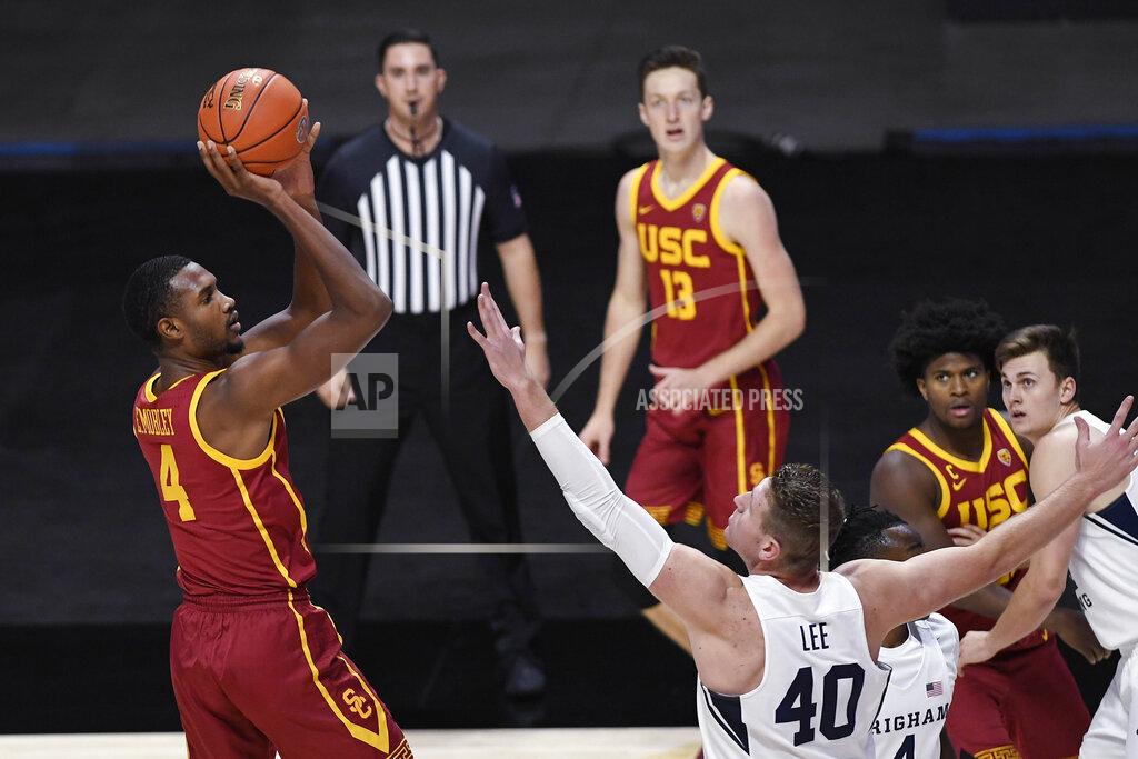 Jessica Hill Southern California's Evan Mobley, left, shoots over BYU's Kolby Lee in the first half of an NCAA college basketball game, Tuesday, Dec. 1, 2020, in Uncasville, Conn. (AP Photo/Jessica Hill)