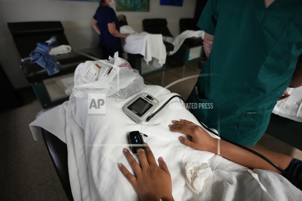 Rebecca Blackwell A medical student, right, and nurse, back, monitor women as they rest before and after getting abortions, Saturday, Oct. 9, 2021, at Hope Medical Group for Women in Shreveport, La. The nation's most restrictive abortion law is driving many women from Texas to seek services in neighboring states. The woman said she was already five weeks along before she realized she was pregnant, and she knew it would be impossible to schedule the required two visits at a Texas clinic. (AP Photo/Rebecca Blackwell)