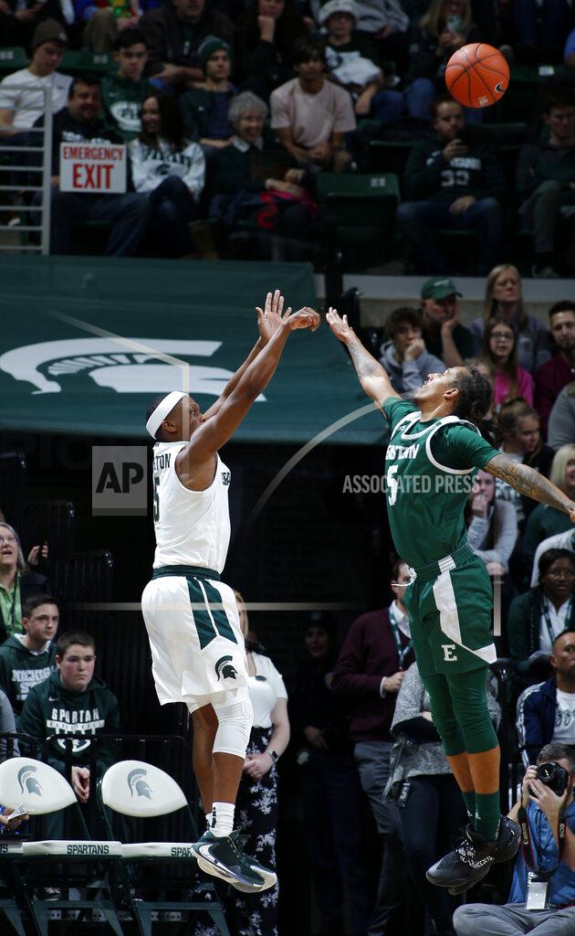 Al Goldis Michigan State's Cassius Winston, left, shoots a three-point basket against Eastern Michigan's Noah Morgan during the first half of an NCAA college basketball game, Saturday, Dec. 21, 2019, in East Lansing, Mich. (AP Photo/Al Goldis)