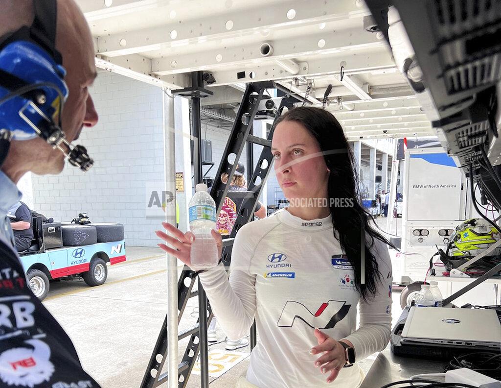 Jenna Fryer IMSA sports car driver Taylor Hagler, right, looks at data with engineer Stefano Galante on Wednesday March 16, 2022, at Sebring International Raceway in Sebring, Fla. Hagler drives for Bryan Herta Autosport and is the second female champion in IMSA history. She races Thursday at Sebring in The Michelin Pilot Challenge race. (AP Photo/Jenna Fryer)