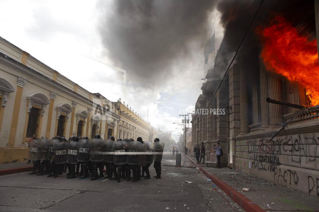 Oliver De Ros Flames shoot out from the Congress building after protesters set a part of the building on fire, in Guatemala City, Saturday, Nov. 21, 2020. Hundreds of protesters were protesting in various parts of the country Saturday against Guatemalan President Alejandro Giammattei and members of Congress for the approval of the 2021 budget that reduced funds for education, health and the fight for human rights. (AP Photo/Oliver De Ros)