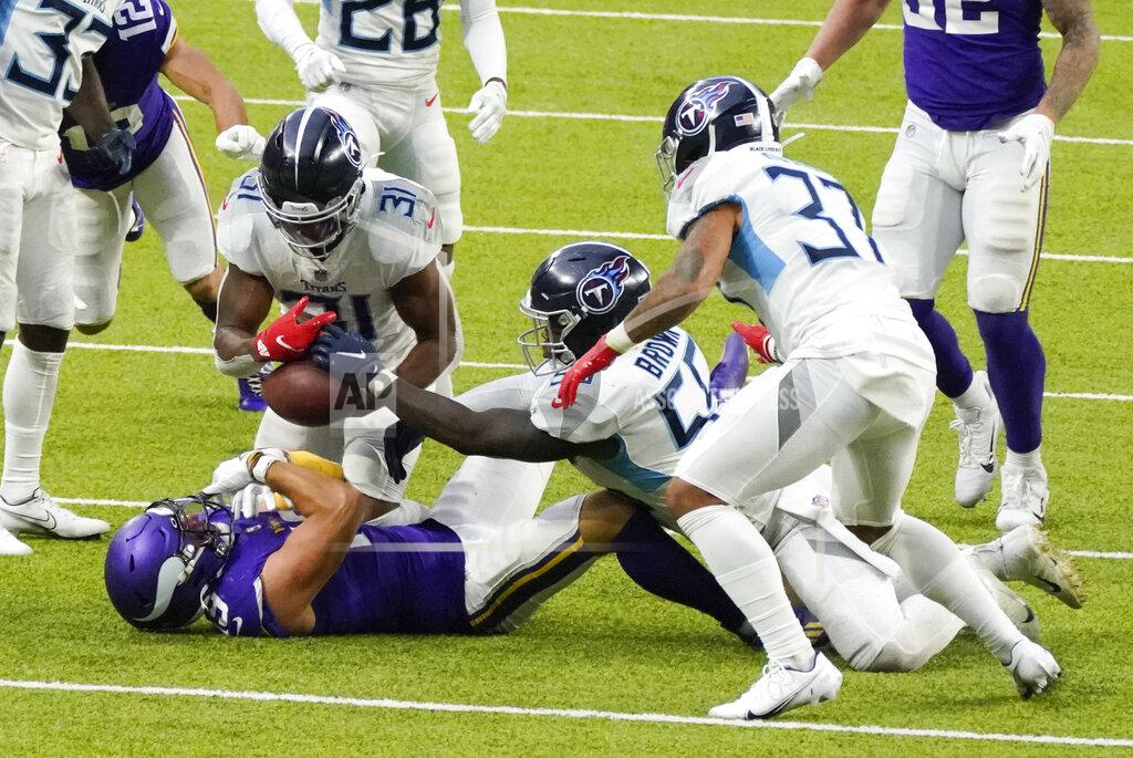 Jim Mone Tennessee Titans free safety Kevin Byard (31), inside linebacker Jayon Brown (55) and safety Amani Hooker (37) strip the ball from Minnesota Vikings wide receiver Adam Thielen during the second half of an NFL football game, Sunday, Sept. 27, 2020, in Minneapolis. (AP Photo/Jim Mone)
