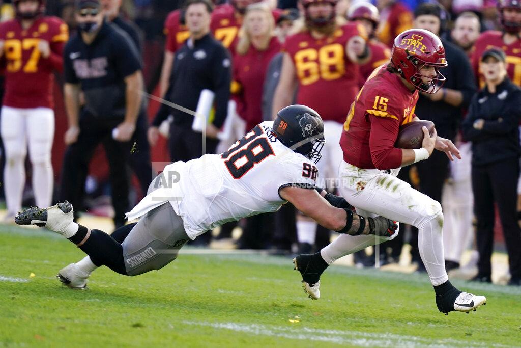 Charlie Neibergall Iowa State quarterback Brock Purdy (15) runs from Oklahoma State defensive tackle Brendon Evers (98) during the second half of an NCAA college football game, Saturday, Oct. 23, 2021, in Ames, Iowa. Iowa State won 24-21. (AP Photo/Charlie Neibergall)