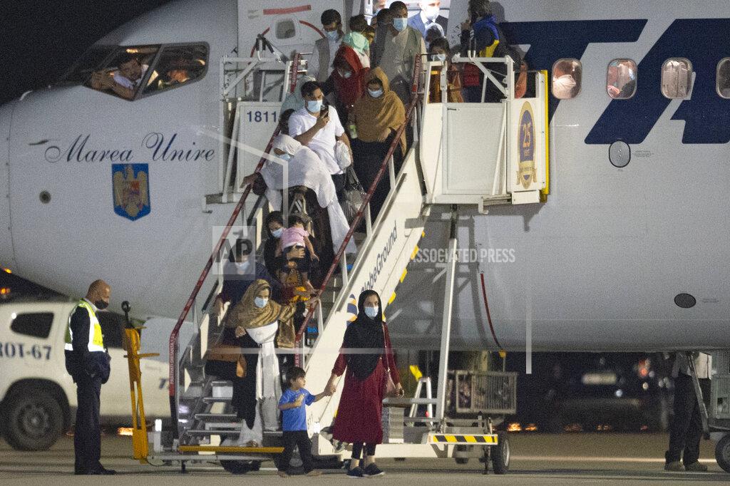 Alexandru Dobre Afghan citizens evacuated by Romanian authorities from Afghanistan disembark an airplane at the Baza 90 military base after being flown in from Pakistan in Otopeni, near Bucharest, Romania, Thursday, Sept. 9, 2021. The Romanian Foreign Ministry organized the evacuation of 156 Afghan citizens, former aides of the Romanian military that operated in Afghanistan, students, human rights activists, journalists, magistrates and their family members, of which 139 arrived to Romania on Thursday night. (AP Photo/Alexandru Dobre)