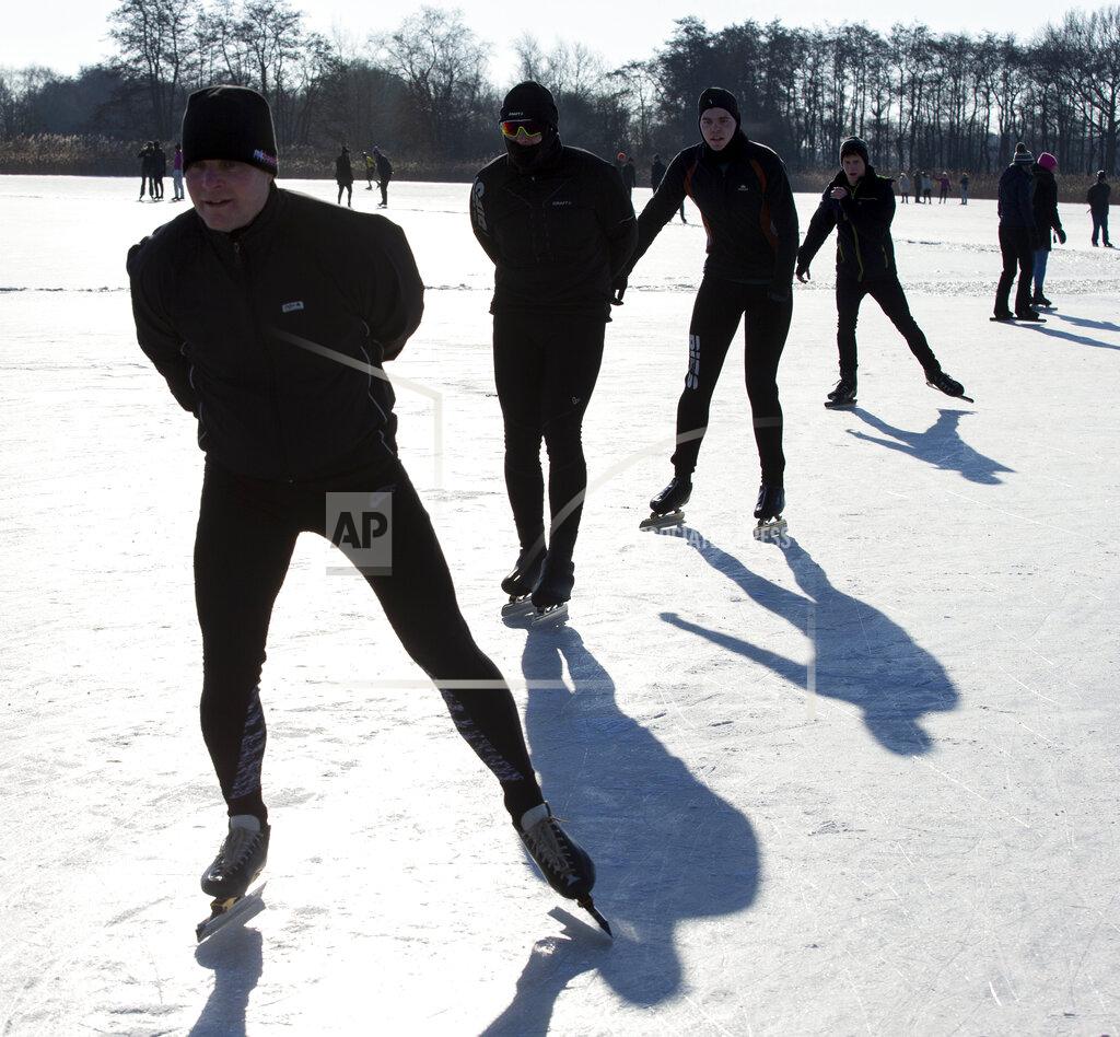 Peter Dejong People skate on Nannewiid Lake in Oudehaske, Netherlands, Friday, Feb. 12, 2021. With many lakes and canals in the Netherlands frozen over, Dutch skating fans flocked to the ice Friday, causing a headache for authorities trying to enforce social distancing measures to stop the spread of the coronavirus. (AP Photo/Peter Dejong)