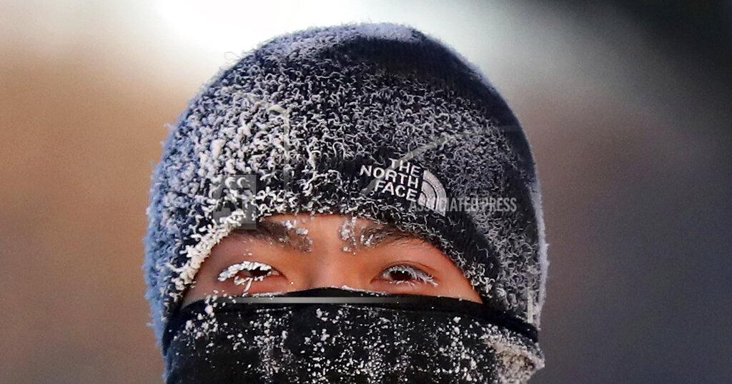 A runner wears the cold on his face while running along West River Parkway hills Thursday, Feb. 13, 2020, near downtown Minneapolis, with temperatures hovering near minus 30 degrees Fahrenheit with wind chills. (David Joles/Star Tribune via AP)