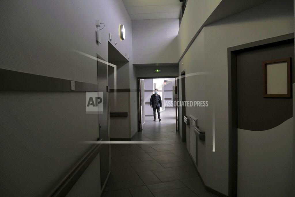 Thibault Camus A patient walks on a corridor of the Rouvray psychiatric hospital, in Rouen, western France, Wednesday, Nov. 25, 2020. Lockdowns that France has used to fight the coronavirus have come at considerable cost to mental health. Surveying points to a surge of depression most acute among people without work, in financial hardship and young adults. (AP Photo/Thibault Camus)