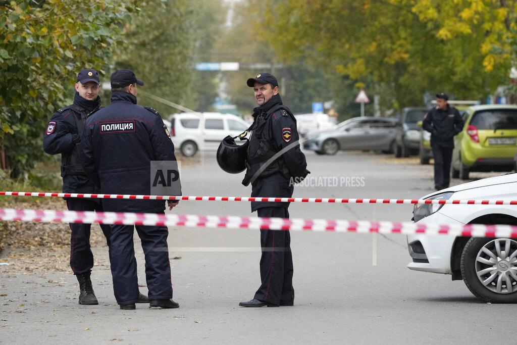 Dmitri Lovetsky Police officers guard an area outside the Perm State University after a shooting in Perm, about 1,100 kilometers (700 miles) east of Moscow, Russia, Tuesday, Sept. 21, 2021. A student opened fire at the university, leaving a number of people dead and injured, before being shot in a crossfire with police and detained. Beyond saying that he was a student, authorities offered no further information on his identity or a possible motive. (AP Photo/Dmitri Lovetsky)