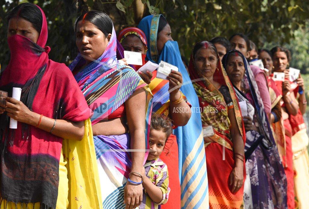 Aftab Alam Siddiqui A child stands with adults waiting in a queue to cast their votes outside a polling station at Paliganj, in the eastern Indian state of Bihar, Wednesday, Oct. 28, 2020. Voting began Wednesday in India’s third-largest state of Bihar, the first major election in the country since the pandemic and a test for Prime Minister Narendra Modi’s popularity as he faces criticism on many fronts. (AP Photo/Aftab Alam Siddiqui)
