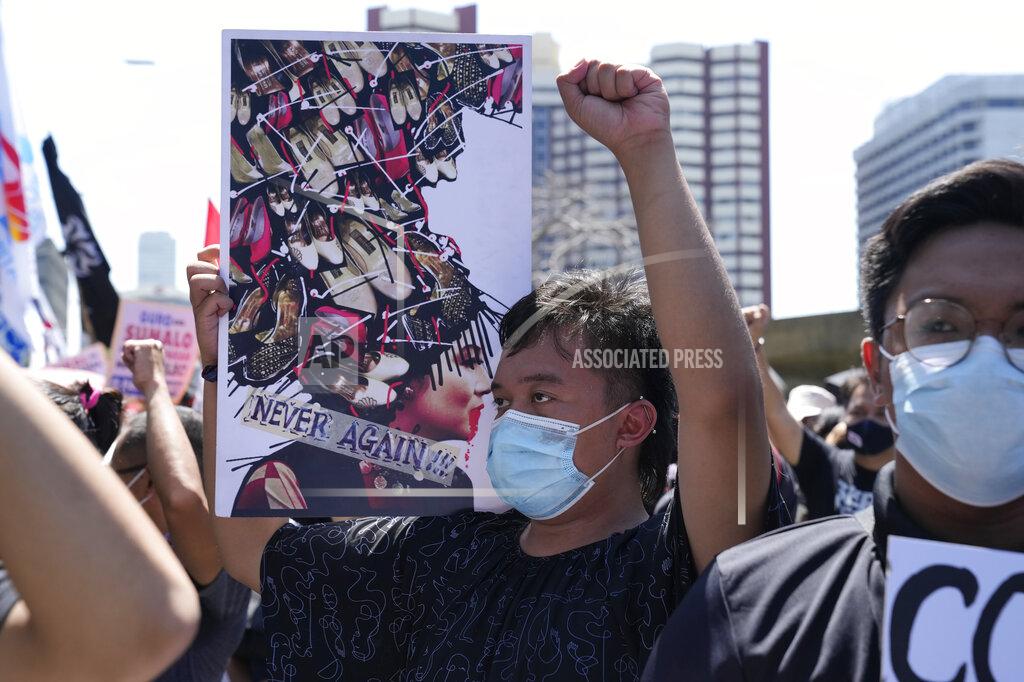 Aaron Favila A protester holds a banner with a picture of former First Lady Imelda Marcos, widow of the late strongman, during a rally against presidential frontrunner Ferdinand "Bongbong" Marcos Jr. and running mate Sara Duterte, daughter of the current president, in Pasay, Philippines, Friday, May 13, 2022. Allies of the Philippines' presumptive next president, Marcos Jr., appear set to strongly dominate both chambers of Congress, further alarming activists after the late dictator's son scored an apparent election victory that will restore his family to the seat of power. (AP Photo/Aaron Favila)