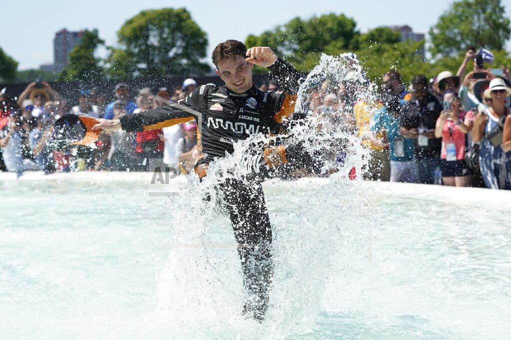 Paul Sancya Pato O'Ward celebrates by jumping into James Scott Memorial Fountain after winning the second race of the IndyCar Detroit Grand Prix auto racing doubleheader on Belle Isle in Detroit Sunday, June 13, 2021. (AP Photo/Paul Sancya)