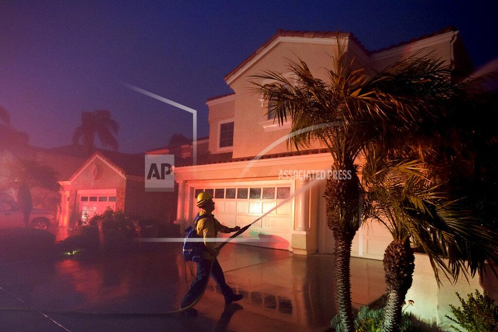 Marcio J. Sanchez A firefighter works to protect a structure during a wildfire Wednesday, May 11, 2022, in Laguna Niguel, Calif. (AP Photo/Marcio J. Sanchez)