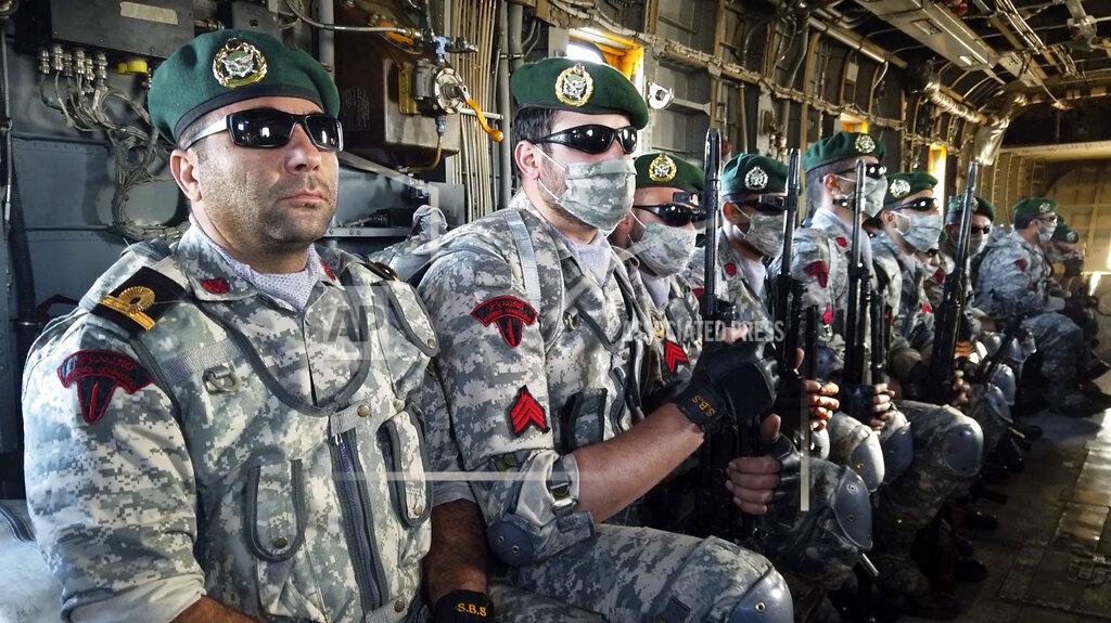 Uncredited This image made from a video released on Wednesday, Jan. 13, 2021, by the Iranian Army shows troops sitting in a helicopter during a navy drill. Iran's navy began a short-range missile drill in the Gulf of Oman on Wednesday, state TV reported, amid heightened regional tensions over Tehran's nuclear program and a U.S. pressure campaign against the Islamic Republic. (Iranian Army via AP)
