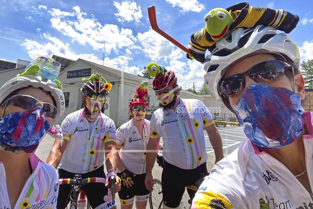 In this July 31, 2020 photo, Pan-Mass Challenge bike riders (from left) Cathy Ellis, Steven Branfman, Stephanie Vail, Jeremy Vail, and Celia Donatio pose for a selfie in Newton, Mass. "Team Kermit" raised close to $554,000 for Dana Farber Cancer Research. PMC founder Billy Starr knew he wouldn't be able to get 10,000 people together this summer for the annual cross-state bike ride that has raised more than $700 million for cancer research. But he also knew he couldn't take the year off. While other events in the $1.4 billion participatory fundraising field shut down during the coronavirus outbreak, the PMC delivered $50 million for the Dana-Farber Cancer Institute. (Photo by Celia Donatio via AP)
