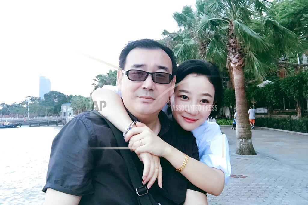 Uncredited FILE - This undated, file photo released by Chongyi Feng shows Yang Hengjun and his wife Yuan Xiaoliang. Australia considers the incarceration of the Chinese-Australian writer who has been tried in Beijing for alleged espionage a case of arbitrary detention, the foreign minister said on Friday, May 28, 2021. Yang faced a closed trial on Thursday. The court deferred its verdict to a later date.(Chongyi Feng via AP, File)