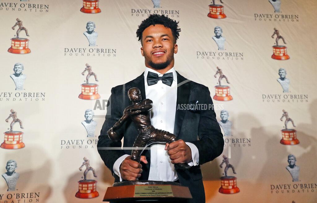 Lm Otero Heisman Trophy winner quarterback Kyler Murray posses with the Davey O'Brien football award he received in Fort Worth, Texas, Monday, Feb. 18, 2019. Murray accepted the Davey O'Brien award in his first public appearance since the Heisman Trophy winner announced his plan to pursue an NFL career rather than report to spring training as a first-round pick of the Oakland A's. (AP Photo/LM Otero)