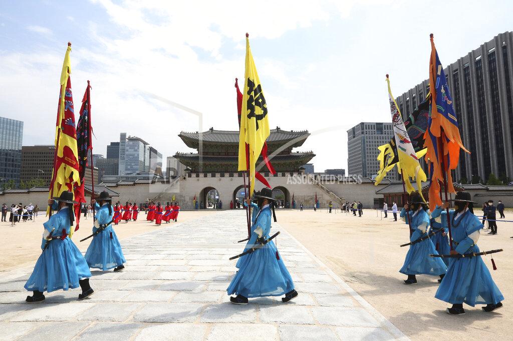 Ahn Young-Joon South Korean Imperial guards wearing face masks move during a reenactment of the Royal Guards Changing Ceremony, which had been suspended due to the new coronavirus, at Gyeongbok Palace in Seoul, South Korea, Thursday, May 21, 2020. (AP Photo/Ahn Young-joon)