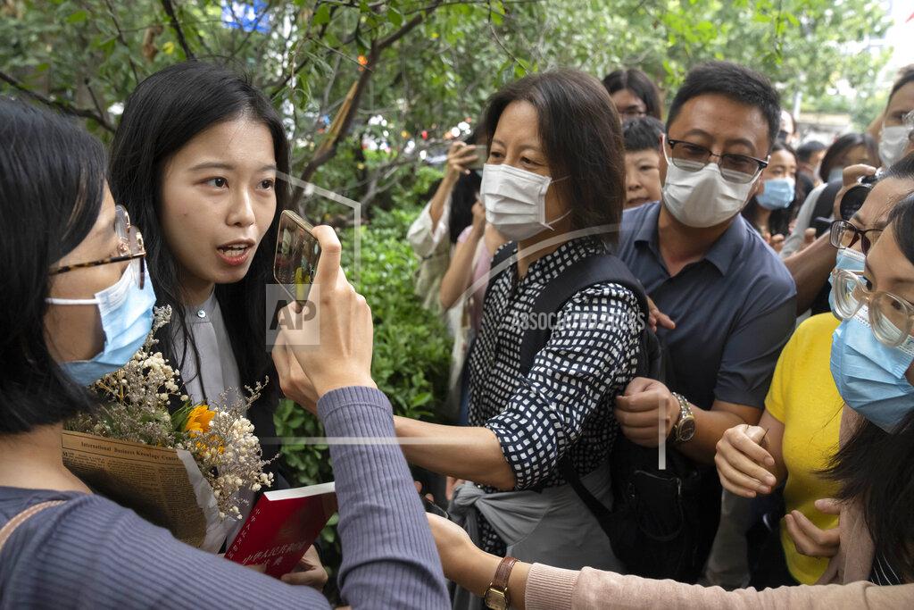 Mark Schiefelbein Zhou Xiaoxuan, left, a former intern at China's state broadcaster CCTV, is accosted by hostile bystanders outside a courthouse in Beijing, Tuesday, Sept. 14, 2021. Zhou became the face of the country's MeToo movement after going public with accusations against a prominent CCTV host in 2018. Since then, even as the movement was shut down by authorities, Zhou has continued to speak out. (AP Photo/Mark Schiefelbein)