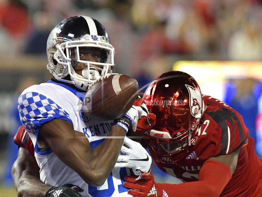 Timothy D. Easley Kentucky wide receiver Isaiah Epps (81) tries to pull in a pass as Louisville defensive back Ori Jean-Charles (42) makes the hit during the second half of an NCAA college football game in Louisville, Ky., Saturday, Nov. 24, 2018. (AP Photo/Timothy D. Easley)