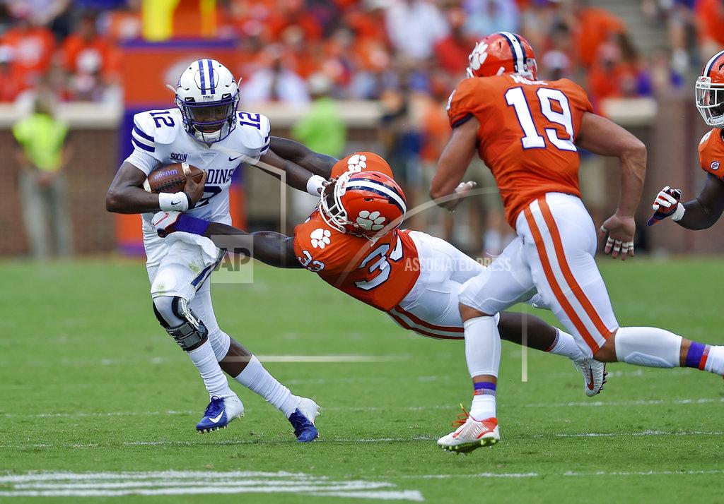 Richard Shiro Furman quarterback JeMar Lincoln is pursued by Clemson's J.D.Davis, center, and Tanner Muse during the first half of an NCAA college football game Saturday, Sept. 1, 2018, in Clemson, S.C. (AP Photo/Richard Shiro)