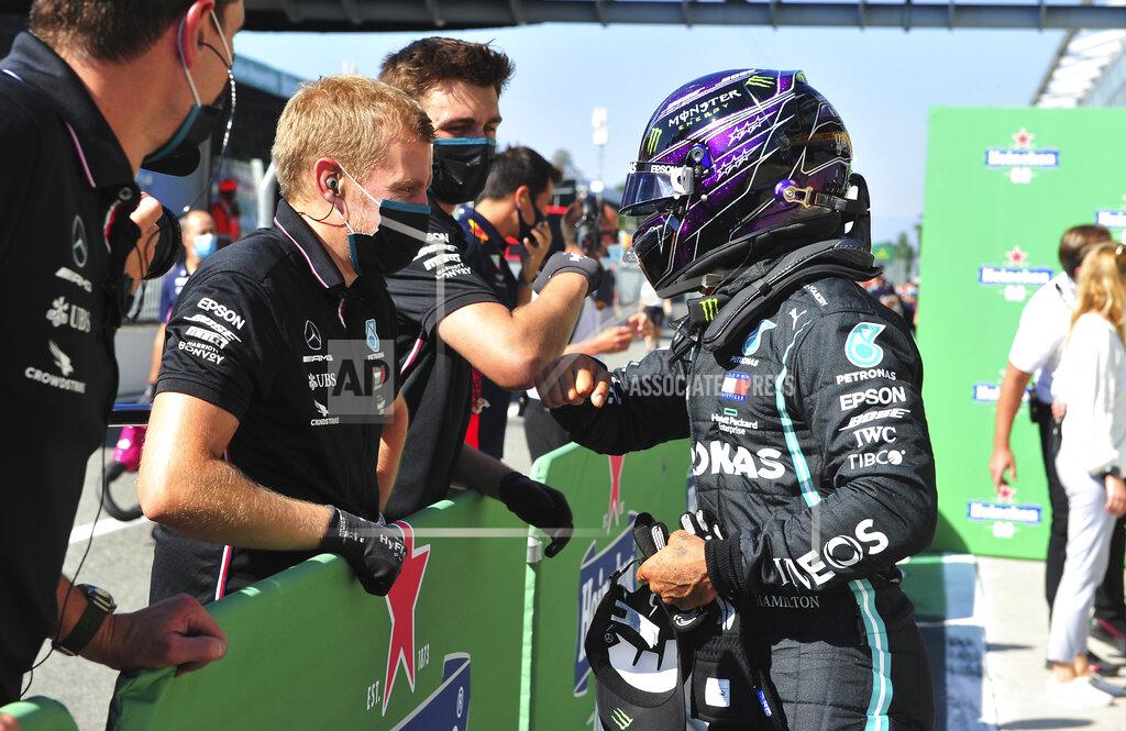 Jennifer Lorenzini Mercedes driver Lewis Hamilton, right, of Britain celebrates after clocking the fastest time during the qualifying session for Sunday's Italian Formula One Grand Prix, at the Monza racetrack in Monza, Italy, Saturday, Sept. 5, 2020. (Jennifer Lorenzini/Pool via AP)