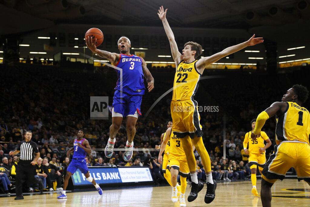 Charlie Neibergall DePaul guard Devin Gage (3) drives to the basket ahead of Iowa forward Patrick McCaffery (22) during the first half of an NCAA college basketball game, Monday, Nov. 11, 2019, in Iowa City, Iowa. DePaul won 93-78. (AP Photo/Charlie Neibergall)