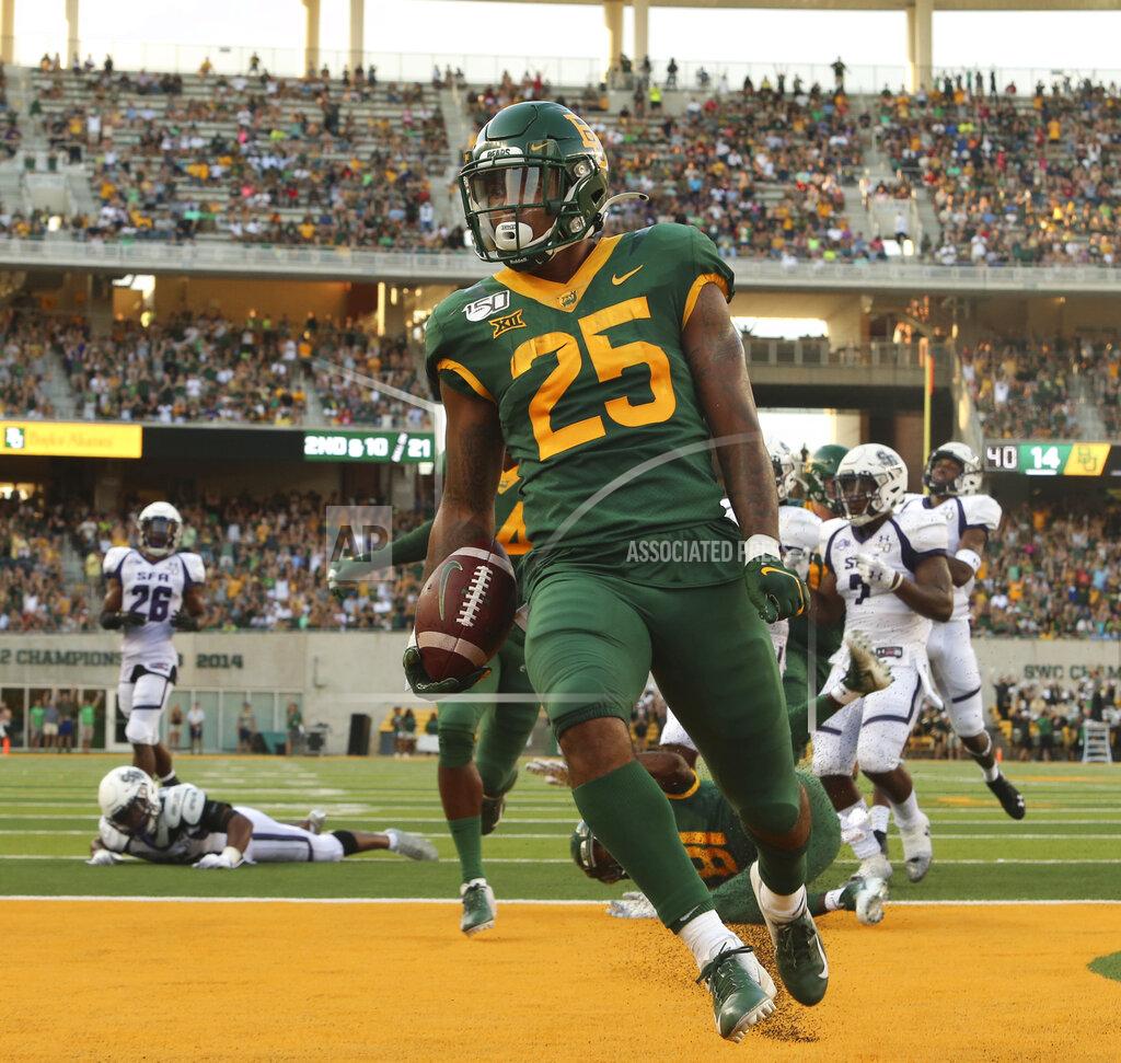 Jose Yau Baylor running back Trestan Ebner (25) scores past the Stephen F. Austin defense in the first half of an NCAA college football game Saturday, Aug. 31, 2019, in Waco, Texas. (Jose Yau/Waco Tribune-Herald via AP)