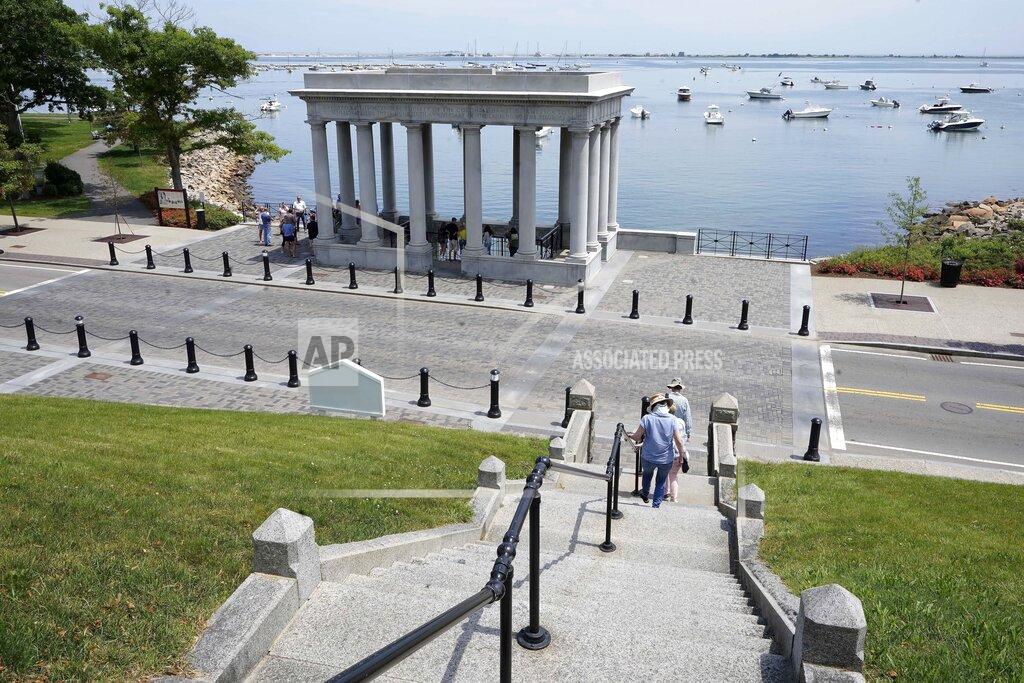 Steven Senne Pedestrians walk down stairs from Cole's Hill toward a pavilion that shelters Plymouth Rock, in Plymouth, Mass., Wednesday, June 9, 2021. Archaeologists are excavating the grassy hilltop that overlooks iconic Plymouth Rock one last time before a historical park is built on the site. (AP Photo/Steven Senne)