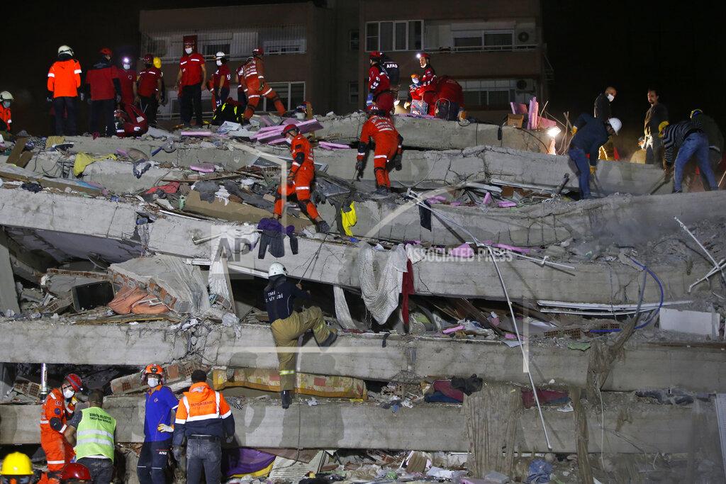 Emrah Gurel Members of rescue services search in the debris of a collapsed building for survivors in Izmir, Turkey, early Saturday, Oct. 31, 2020. A strong earthquake struck Friday in the Aegean Sea between the Turkish coast and the Greek island of Samos, killing several people and injuring hundreds amid collapsed buildings and flooding. (AP Photo/Emrah Gurel)