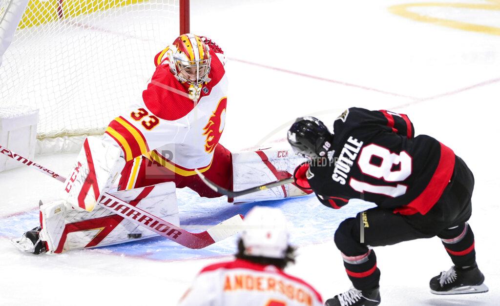 Sean Kilpatrick Calgary Flames goaltender David Rittich (33) makes a save on a shot from Ottawa Senators left wing Tim Stutzle (18) during second period NHL hockey action in Ottawa on Saturday, Feb. 27, 2021. (Sean Kilpatrick/The Canadian Press via AP)
