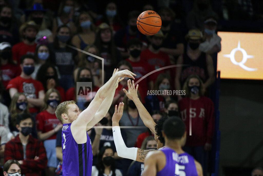 Young Kwak Portland guard Tyler Robertson, left, shoots over Gonzaga guard Julian Strawther during the first half of an NCAA college basketball game, Saturday, Jan. 29, 2022, in Spokane, Wash. (AP Photo/Young Kwak)
