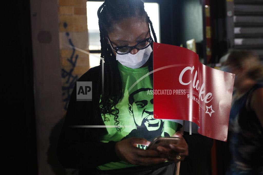 Kathy Willens Supporter Chloe Natacha checks her phone while waiting for Rep. Yvette Clarke, D-N.Y., to arrive at Clarke's campaign headquarters Tuesday, June 23, 2020, in the Brooklyn borough of New York, on the night of the state's primary. (AP Photo/Kathy Willens)