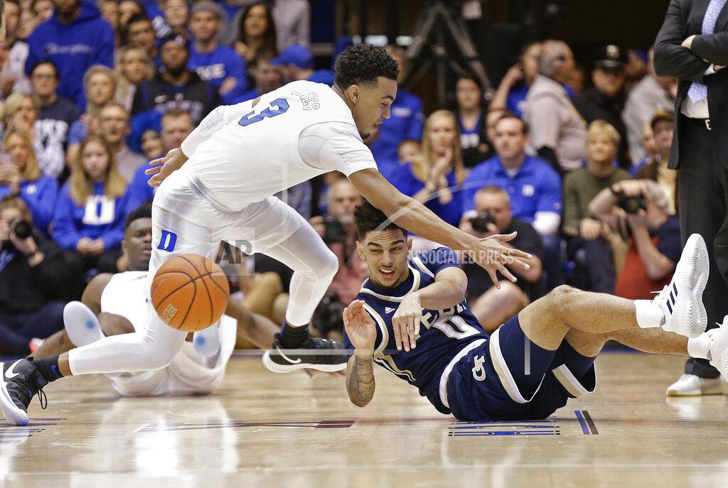 Gerry Broome Duke's Tre Jones (3) reaches in as Georgia Tech's Michael Devoe (0) passes from the floor during the first half of an NCAA college basketball game in Durham, N.C., Saturday, Jan. 26, 2019. (AP Photo/Gerry Broome)